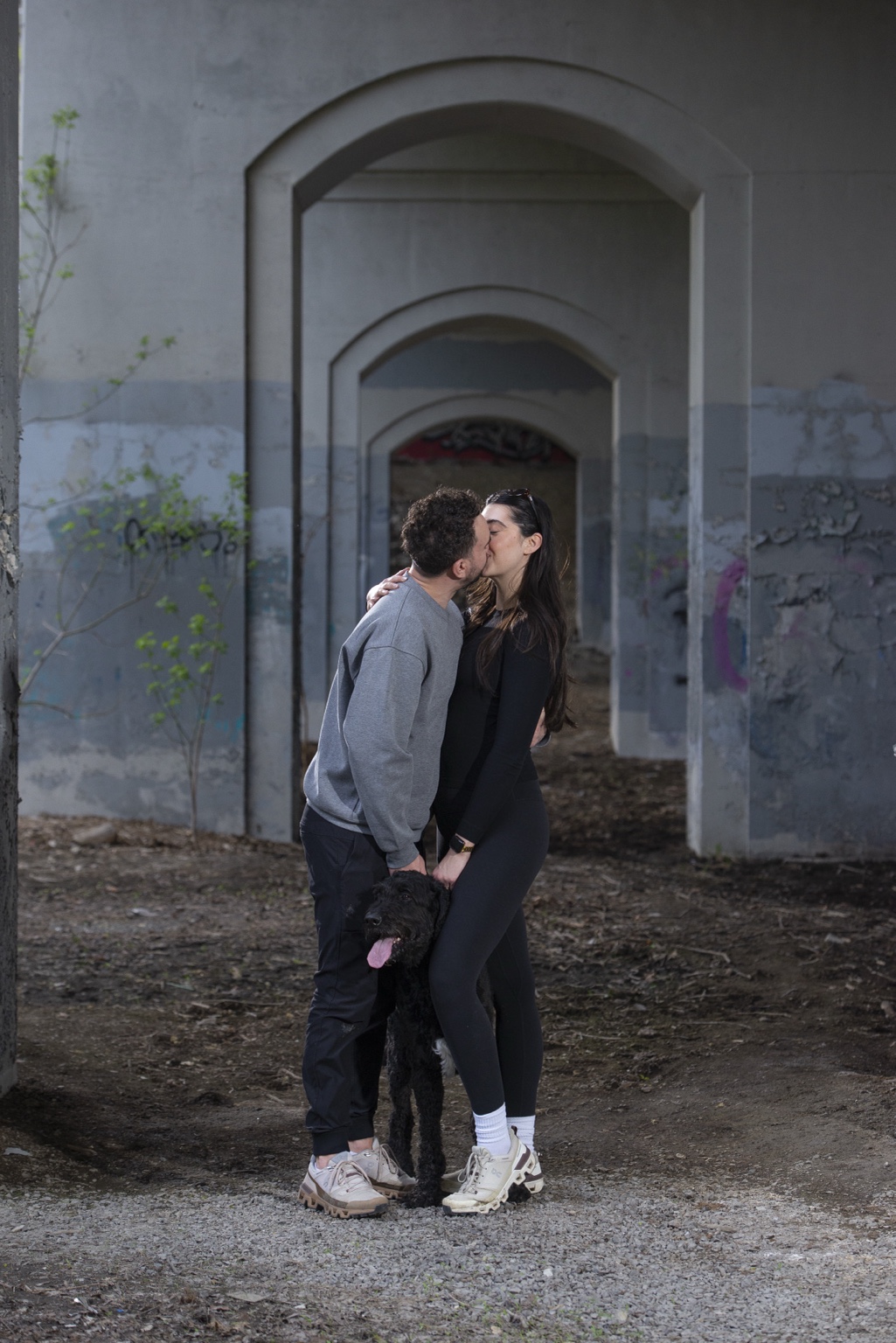 Cole and Claudia sharing a kiss with their dog
